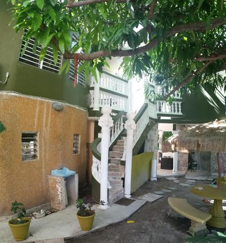 a building with a staircase in front of it at Villa Marsana in Aguada