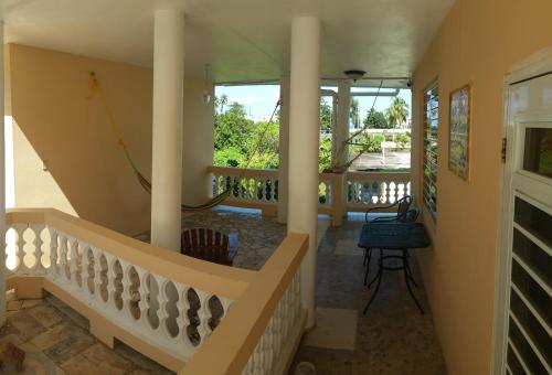 a hallway of a house with columns and a staircase at Villa Marsana in Aguada