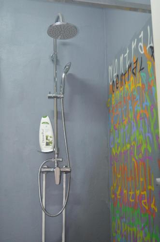 a bathroom with a shower with a phone at Central Park Studios in Bucharest