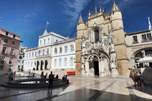 a group of people standing in front of a building at Oleiros Rooms City Center in Coimbra