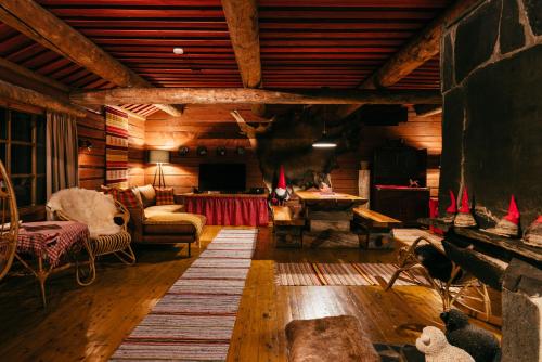 a living room with wooden walls and wooden floors at Ollero Eco Lodge (including a glass igloo) in Rovaniemi