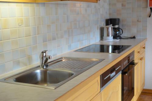 a kitchen counter with a stainless steel sink at Ferienwohnung Kogelblick in Virgen