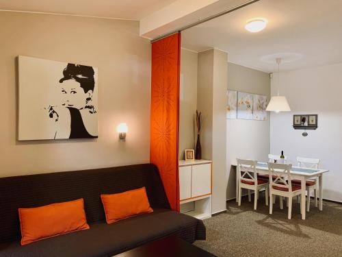 a living room with a couch and a dining room at Apartmany Jasna Chopok in Demanovska Dolina