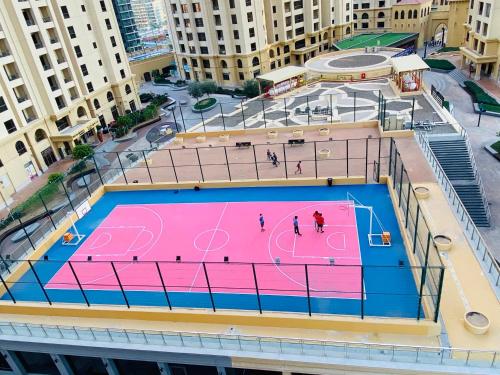 
a pool of water with a basketball hoop on top of it at Bollywood Beach Hostel in Dubai
