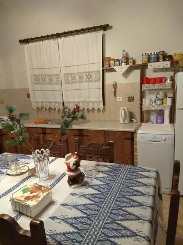 a kitchen with a table with a blue and white table cloth at Angelic in the mountains in Kaisárion