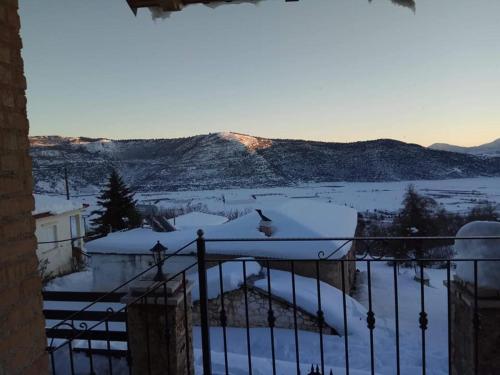 a view of a snow covered mountain from a balcony at Angelic in the mountains in Kaisárion