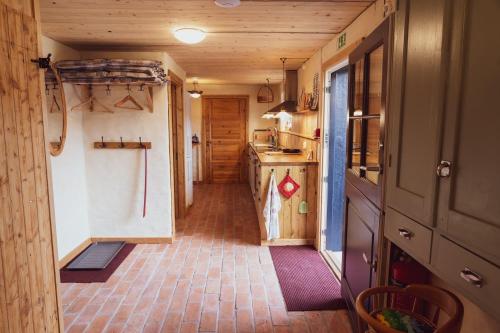 a hallway of a tiny house with a kitchen at Brösarp Källagården Lilla Gårdslägenheten in Brösarp