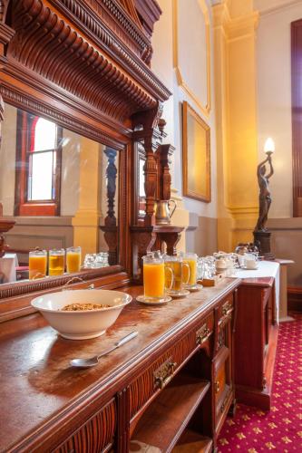 a table with glasses of orange juice on it at Vue Grand Hotel in Queenscliff