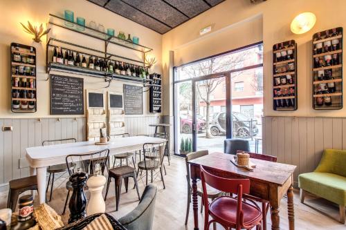 a restaurant with a bar and tables and chairs at City Guest House in Rome