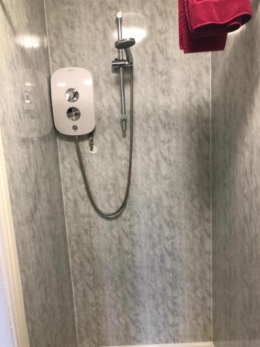 a shower in a bathroom with a red towel at Don Valley hotel Sheffield arena in Sheffield