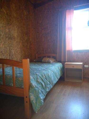 a bedroom with a bunk bed and a window at Cabanas Yessi in Castro