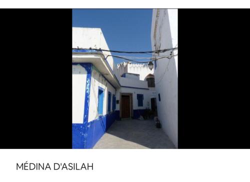 a group of buildings with blue and white walls at TANGER/ASILAH: APPART 50m2 FACE MER ET PISCINES, 5 PLACES, TOUT ÉQUIPÉ+WIFI+CLIM in Briech