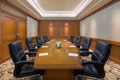 a conference room with a long table and chairs at Millennium Hotel Sirih Jakarta in Jakarta