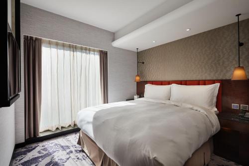 Postel nebo postele na pokoji v ubytování Tango Inn Taipei ZhongShan