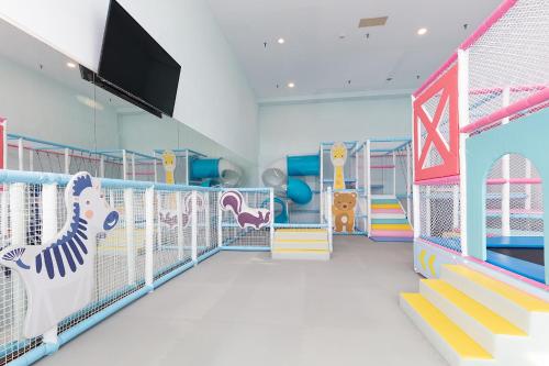 a childrens play room with a slide and play equipment at Howard Plaza Hotel Hsinchu in Hsinchu City
