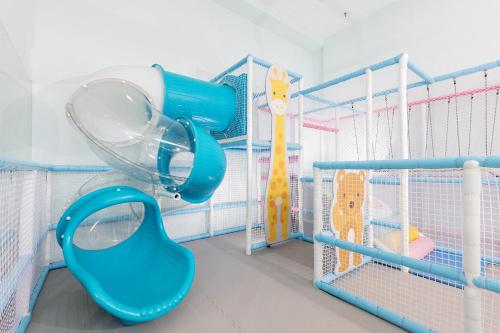 a childrens room with a play area with a blue swing at Howard Plaza Hotel Hsinchu in Hsinchu City