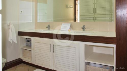 a bathroom with two sinks and a mirror at Fantastic spacious beachfront VILLAVACANCES in Grand Baie
