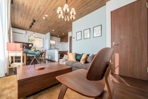 a living room with a couch and a chair at Villa Fuji Bon Voyage Mori in Fujikawaguchiko