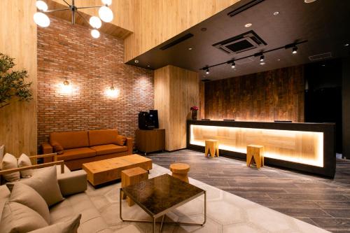 a living room with a couch and a table at Hotel Wing International Sapporo Susukino in Sapporo