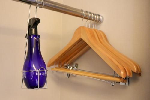 a bottle of wine is hanging on a rack at PORTA INN bentencho in Osaka