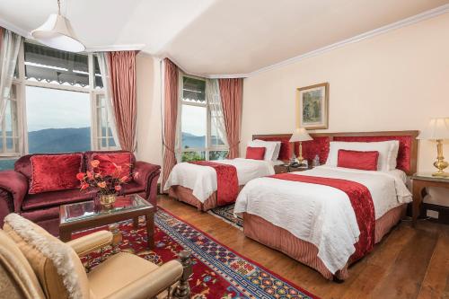 a hotel room with two beds and a couch at The Elgin Silver Oaks - Heritage Resort & Spa in Kalimpong
