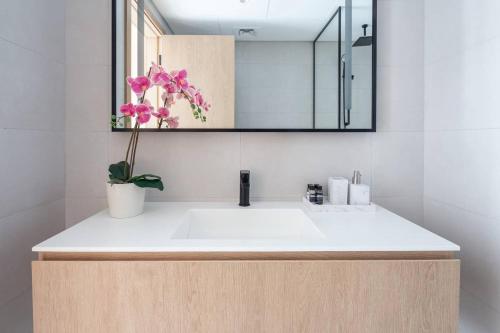 a bathroom with a white sink and a mirror at Frank Porter - Marquise Square in Dubai