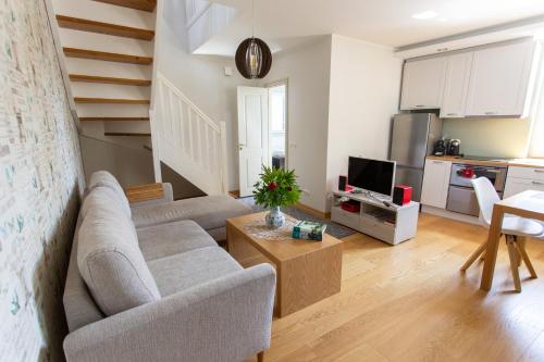 a living room with a couch and a table at Silbernagel Apartment in Kuressaare