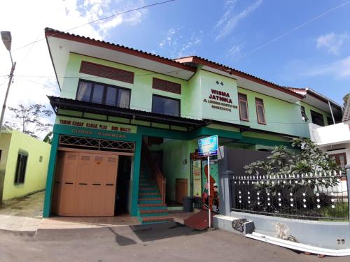 a house with a green and white at OYO Life 2884 Wisma Jatnika Syariah in Kuningan