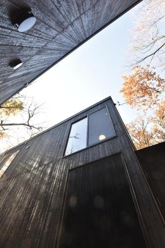 a building with a window on the side of it at Shizuku Villas in Hakuba