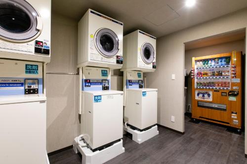 a room with two machines and a vending machine at Hotel Wing International Sapporo Susukino in Sapporo