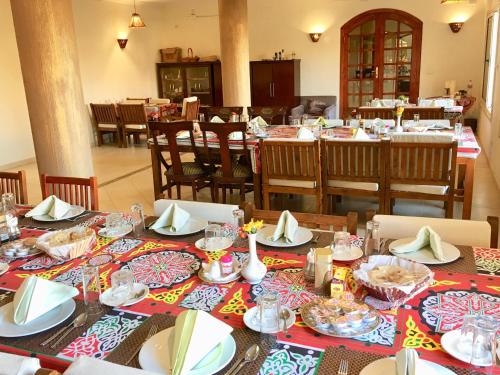 a table topped with plates filled with food at New Memnon Hotel in Luxor