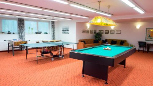 a living room with two ping pong tables in it at Hotel Montjola Nova in Schruns