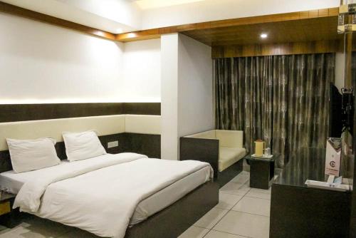 a bedroom with two beds and a television in it at Hotel Apex Inn in Vapi