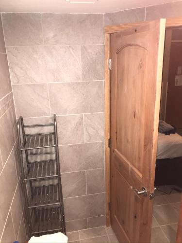 a bathroom with a shower with a shelf next to a door at 4429 Beaver Run Resort in Breckenridge