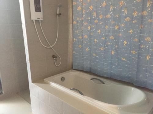 a bath tub in a bathroom with a shower at Cousin Koh Kho Khao Beach in Ko Kho Khao