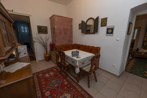a kitchen with a table and chairs in a room at Villa Tabody in Révfülöp