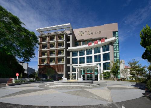 a large building with a circle in front of it at Sun Moon Lake Teachers' Hostel in Yuchi