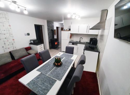 a kitchen and a living room with a table and chairs at Apartment for your Holiday in Ramingstein