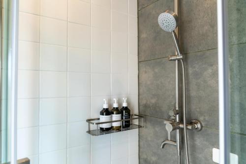 a shower with bottles of wine on a shelf at RuGu Glamping Resort in Miyako Island