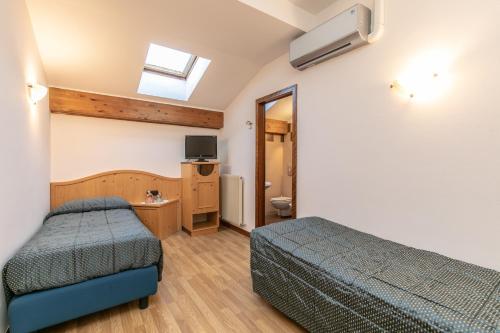 Cama o camas de una habitación en Albergo Conca Verde