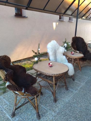 two tables and chairs with teddy bears on them at Vysoké Tatry Gerlaška in Gerlachov