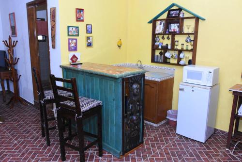 a kitchen with a counter and a sink and a refrigerator at Cancun Guest House 2 in Cancún