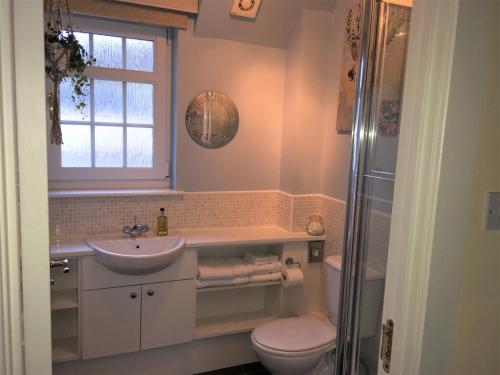 a bathroom with a sink and a toilet and a window at Tweed View B&B in Peebles