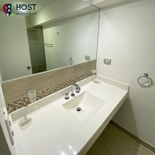 a bathroom with a white sink and a mirror at Host - San Isidro Sta Catalina in Lima