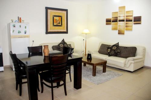 a living room with a table and a couch at The Plaza Apartment - Bethlehem in Bethlehem