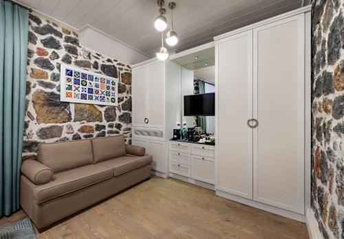 a living room with a couch and a stone wall at Catch Sultanahmet-Special Class in Istanbul