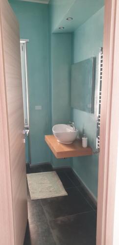 a bathroom with a white sink and a mirror at Casa sul mare in Salerno