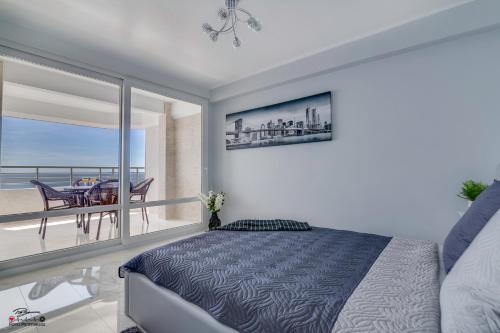a bedroom with a bed and a view of the ocean at La Paz Molo in Torrevieja