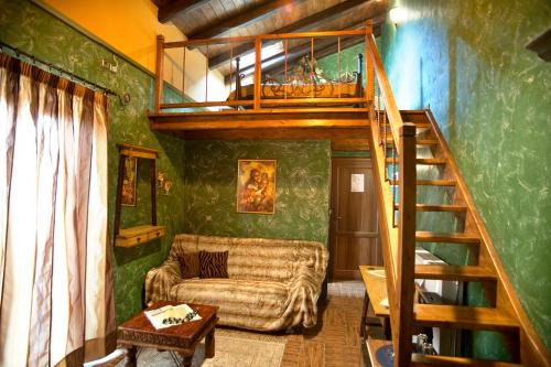 a living room with a loft bed and a couch at Ξενώνας Οντάς και Spa in Arachova