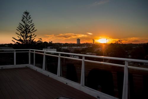 a sunset on a balcony with a deck at Hotel Bahamas in Montevideo